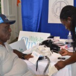 A nurse from the Walk-In Clinic screens an attendee the Post-storm Advisory Clinic.