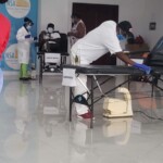 A health worker sanitizes in preparation for a blood donor.