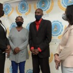 Maxine Seymour, Director of Corporate Communications (l) and Catherine Williams, Vice President of Finance speak with Decoda Butterfield and Terrel Knowles, two of the recipients.