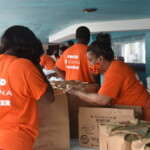 Cassandra Adderley, Supervisor, Group Billings, Colina Insurance Limited and team members assisting with food parcel preparation. AHVIA J. CAMPBELL