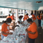 Team members of Colina’s Group and Health Department packing food parcels for distribution to the community. AHVIA J. CAMPBELL