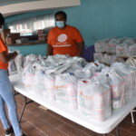 (l to r): Anastacia Gray, Receptionist and Darneisha Ferguson, Claims Adjudicator, Group and Health Benefits, Colina Insurance Limited packing food parcels at The Bahamas Feeding Network. AHVIA J. CAMPBELL