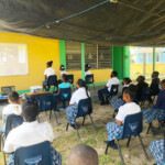 Students at Centreville Primary School outdoors under a tent as they Celebrate WE! with performances by C-Force.