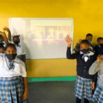 Students at Centreville Primary School outdoors under a tent as they Celebrate WE! with performances by C-Force.