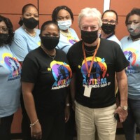 (front row l to r) Shantelle Dames, Marketing Administrator; Phil Smallwood, Director of Sales, Agency Services. (back row l to r) Clothie Lockhart, Sales Training Manager; Andrea Davis-Rolle, Financial Services Representative; Desiree Wells, Marketing Assistant; Karen Sweeting, Manager, Agency Services; Mitzi Barnett, Financial Services Representative bring awareness to autism in their R.E.A.C.H t-shirts.