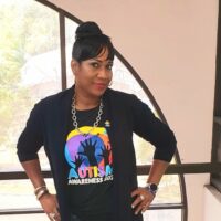 Fashionable autism awareness: Bridgette P. Sands, IFA,MFA, Financial Advisor models her REACH t-shirt.