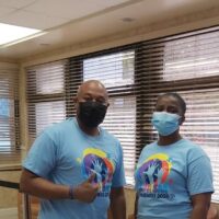 C. Kino McCartney, Branch Manager, Collins with DeAndrea Lewis, Vice President, Life Operations in their blue autism t-shirts.