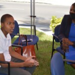 Obasi Bosland, an athletic 12-year-old with autism, makes a new friend in Maxine Seymour, Director, Corporate Communications, Colina who he greeted with a high five.