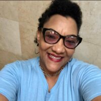 Colina’s friendly receptionist, Monique Collie, pauses to strike a pose in her blue autism awareness shirt.