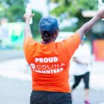 Maqueria Rolle, Customer Service Representative at Colina, proudly volunteering. The Company donated water for Fun, Run, Walk participants as part of the partnership.