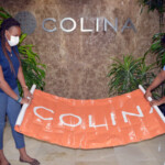 (l to r) Chantal A. Horton, Communications Officer, Corporate Communications, Colina Insurance Limited and Jodell Roberts, Board Member, JBLN pack a Colina banner to be placed at the Field of Dreams.