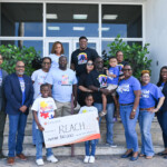 Front row (l to r) Marcus J. Bosland, Resident Actuary at Colina and father of an autistic son; Dwayne Gibson, Chairman, Board of Directors, R.E.A.C.H.; “Au-some” Alvin Hepburn and his sister hold the cheque; “Au-some” Joseph ‘Josie’ Pratt in father’s arms; Sandra Smith, Monique Collie, Maxine Seymour, Chantal A. Horton, Peter Isaacs, Crystal Glinton, Colina along with the Hepburn and Pratt families at the 308 East Bay Street location on Friday, April 1, 2022.