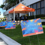 Autism lawn signs are placed outside the 308 building show support for our Autism community.