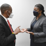 (l to r) Dr. Ricardo P. Deveaux, President & CEO, BPSSYF shares BPSSYF initiatives with Maxine V. Seymour, Director, Corporate Communications, Colina.