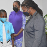 (l to r) Caiden Moxey tells Maxine V. Seymour, Director, Corporate Communications, Colina how high school is progressing and what his plans are for the future.