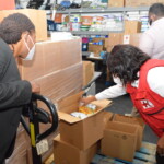 (l to r) Maxine V. Seymour, Director, Corporate Communications, Colina and Lisa Pinder, Director General, Bahamas Red Cross inspected a box containing supplies prior to delivery.