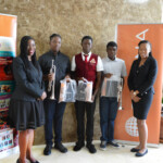 (l to r) Maxine V. Seymour, Director, Corporate Communications (left) and Chantal A. Horton, Communications Officer, Colina (right) present Caleb Sears, Over 18 Audience Choice and Overall winner; Hudson Sterlin, Under 18 Audience Choice winner and Shaquille Butler, Under 18 Audience Choice and Overall winner with gift bags from Colina.