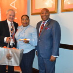 Sandra Walkes (center) accepts her award from Philip Smallwood, Director of Sales and Kino McCartney, Branch Manager.