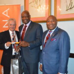 Philip Smallwood, Director of Sales (l) and Kino McCartney, Branch Manager (r) present Wayne Miller with his award.