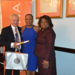 Yvonne Gibson-Sands proudly accepts her award from Philip Smallwood, Director of Sales (l) and Clothie Lockhart, Sales Training Manager (r).