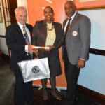 Philip Smallwood, Director of Sales (left) and Jeffrey Randall, Branch Manager (right) proudly awarding Helen Williams with her award.