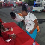 (l to r) Colina employees clock in after The Bahamas’ AIDS Foundation event.