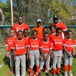 Jordan Gibson, head coach; assistant coach and players of Colina’s Astros Coach-Pitch baseball team with Maxine Seymour, Director of Corporate Communications, Colina