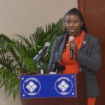 Maxine V. Seymour, Director, Corporate Communications, Colina speaks to audience at Sandilands Rehabilitation Centre Geriatric Push-a-thon press conference.