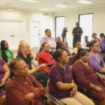 Colina employees listen intently as Sales representative Sandra Walkes asks a question.