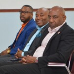 Leonardo Ferguson, Chief Group Internal Auditor; Kino McCartney, Branch Manager and Jeffrey Randall, Branch Manager look on while D’Andra Johnson delivers a message.
