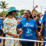 Dame Cynthia Alexandria "Mother" Pratt, Governor General prepares to cut the ribbon to officially start the 13th Annual Pushathon as Maxine V. Seymour, Director, Corporate Communication, Colina and event patron, Rev. Dr. Carrington Pinder look on.