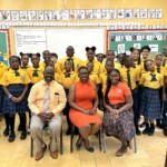 Dr. Clinton Josey Sr., Principal, Palmdale Primary School; Maxine Seymour, Director, Corporate Communications, Colina and Diana Curtis, Literacy Coordinator, Palmdale Primary School with Curtis’ grade four class