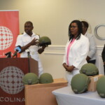 Commander Edward Fritz showcases features of the ballistic helmets.