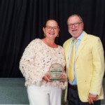 Karen held her award with pride as she posed for a picture with Chief Executive Officer, Emanuel Alexiou.