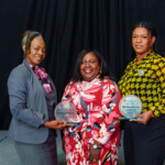 Director of Human Resources, Patrica Bain, is surrounded by Awardees, Tamara Ramsey and Anishka Culmer.