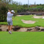Andrew lines up for a perfect swing at the golf tournament.