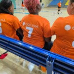 Some athletes watched and supported the team from the bench.