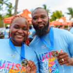 Celina Rolle, Communications Administrator, and Frank Ellis, Facilities Manager, show off their medals.