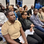 Family, friends and colleagues reflect in solemn remembrance as they pay their respects.