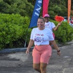 Samantha Addeley, Manager, Life Claims Unit, dashes to the finish line followed by Bianca Seymour, Reinsurance & Subrogation Administrator.