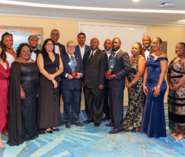 Font row (l to r): Maxine V. Seymour, Director, Communications; Catherine Williams, Vice President, Finance; Patricia Bain, Director, Human Resources; Sapna Chatlani, Vice President, Group & Health Benefits; Emanuel M. Alexiou, BIA Honouree and Colina CEO; Julian Rolle, Bahamas Insurance Association Chairman; Ramon Gregory Bonamy; Natasha Demeritte-Burrows, Human Resources Administrator; Paula-Maria Hospedales, Reinsurance Administration Manager; DeAndrea Lewis, Vice President, Life Operations & Sales; Andrew Alexiou, Managing Director, Apollo Family Office Limited. Back row (l to r) Chantal A. Horton, Manager, Communications; Derick McIntosh, Financial Controller; Marcus Bosland, Chief Operating Officer, Colina; Brandon Deyalsingh, Chief Actuary; Jeffrey Randall, Branch Manager and Wayne Miller, Branch Manager.