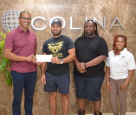 COO, Marcus Bosland, presents a cheque to Chester Robards and his Chickcharney Challenge team.
