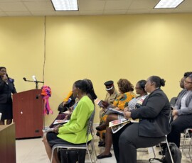 Attendees listen as Sophia Thompson-Williams explains why women need to be safe space for other women going through difficult situations.