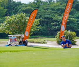 Mid-swing action on the course highlighted by a pop of Colina Orange.