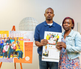 Deron Brice, Special Olympian, poses next to his group photo that made the cover.