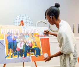 Sustainable Development Goals Offcier, Hydie Knowles, autographs her name on the official poster.