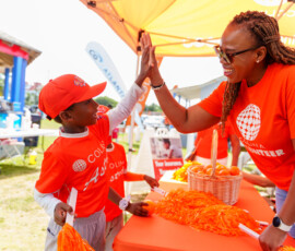 Communications Manager, Chantal A. Horton, high-fives a player.