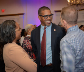 Marcus Bosland, Chief Operating Officer of Colina and Paula Hospedales, Reinsurance Administration Manager of Colina, engage with guests.