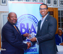 (l to r) Julian Rolle, BIA Chairman awards Marcus Bosland, Chief Operating Officer and Deputy Chair (Life and Health), BIA with an appreciation award for his loyalty and commitment to the BIA.