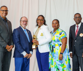 Top Producer of the Year Sandra Smith is joined on stage by Marcus Bosland, COO; Emanuel M. Alexiou, CEO; DeAndrea Lewis, Vice President of Life Operations and Sales; and Elrod Outten, Director of Sales.